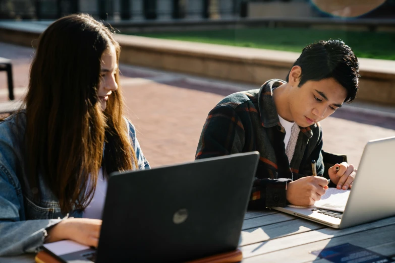 a couple of people sitting at a table with laptops, unsplash, academic art, outside intricate, lachlan bailey, pokimane, writing on a clipboard