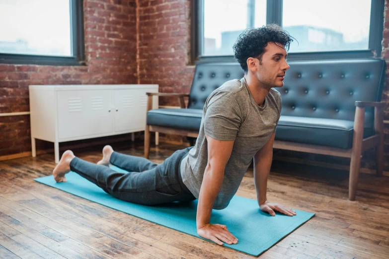 a man doing an exercise on a yoga mat, by Rachel Reckitt, background image, sam nassour, profile image, instagram picture