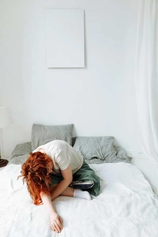 a woman laying on top of a white bed, by Emily Shanks, trending on pexels, visual art, red haired teen boy, hunched over, woman crying, gif