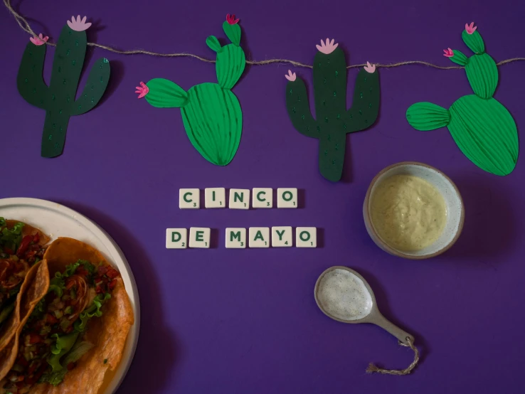 a plate of food sitting on top of a table, inspired by Germán Londoño, purple and green, lettering, cacti, mayo