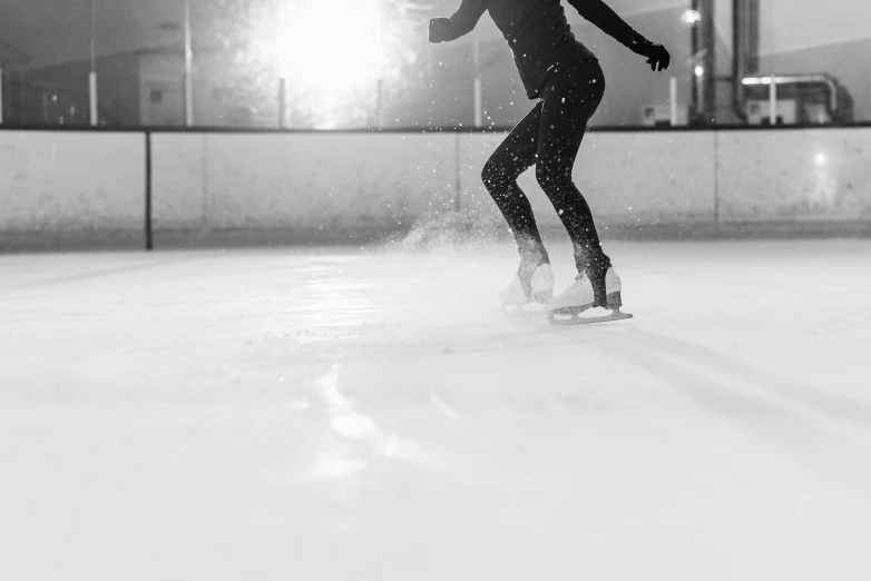 a black and white photo of a person on a skateboard, by Emma Andijewska, pexels contest winner, frozen and covered in ice, dynamic skating, in the evening, sport