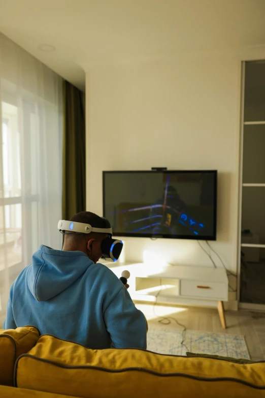 a man sitting on a couch in front of a tv, holography, using a vr headset, studying in a brightly lit room, epic 3 d omolu, kano)