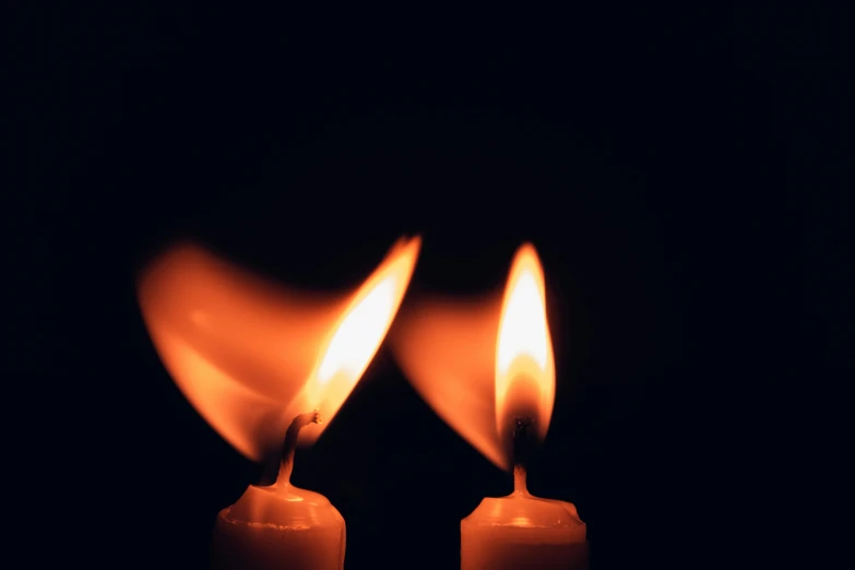 two lit candles in the dark, an album cover, pexels, mourning, flame colors bright, profile image, multiple stories