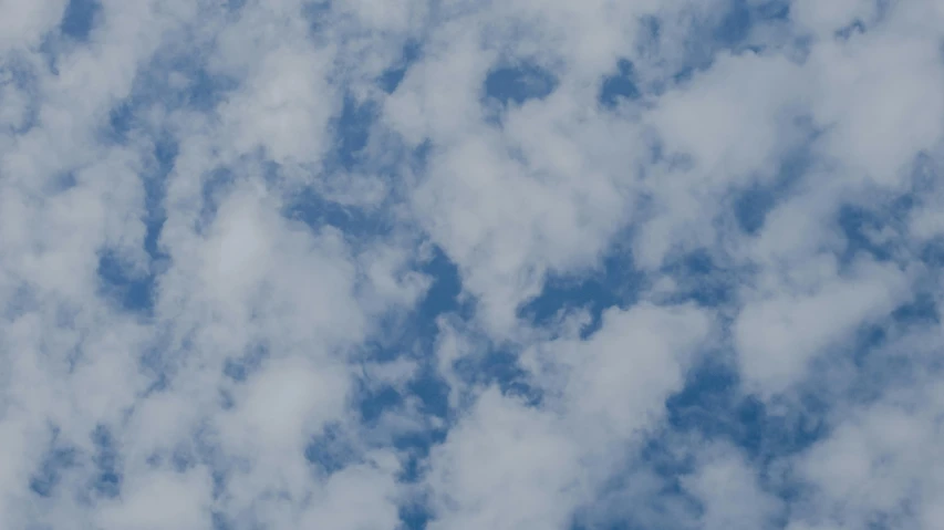 a large jetliner flying through a cloudy blue sky, an album cover, by Carey Morris, pexels contest winner, minimalism, sitting in a fluffy cloud, high angle close up shot, today\'s featured photograph 4k, layered stratocumulus clouds