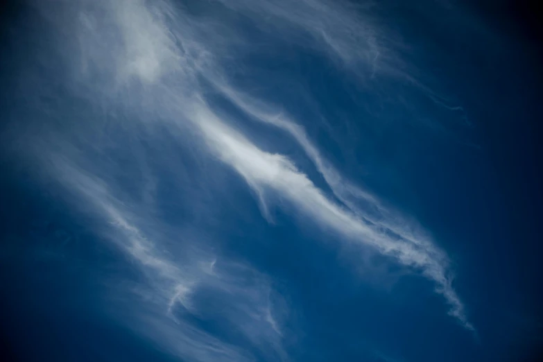 a man riding a snowboard on top of a snow covered slope, an album cover, inspired by George Frederic Watts, pexels contest winner, lyrical abstraction, cloud nebula, thin blue arteries, contrails, a still of an ethereal