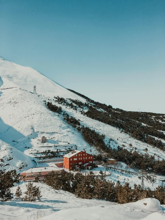 a red house sitting on top of a snow covered mountain, arrendajo in avila pinewood, 8k 28mm cinematic photo, reykjavik junior college, distant photo