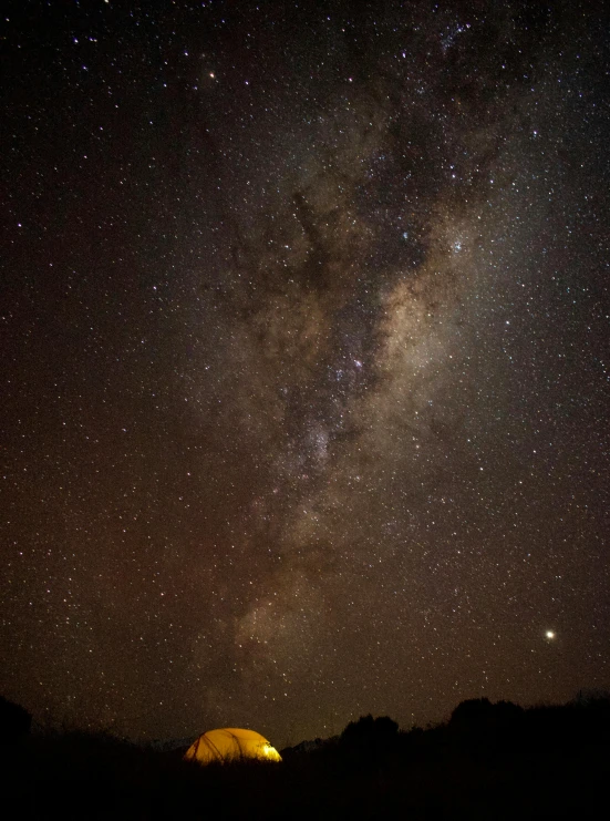 a tent at night with the milky in the background, by Peter Churcher, pexels contest winner, light and space, panorama view of the sky, southern cross, medium closeup, brown