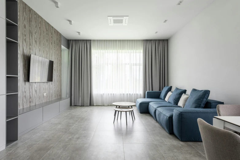 a living room filled with furniture and a flat screen tv, inspired by Emilio Grau Sala, trending on cg society, minimalism, tiles curtains, soft grey and blue natural light, smooth solid concrete, 15081959 21121991 01012000 4k