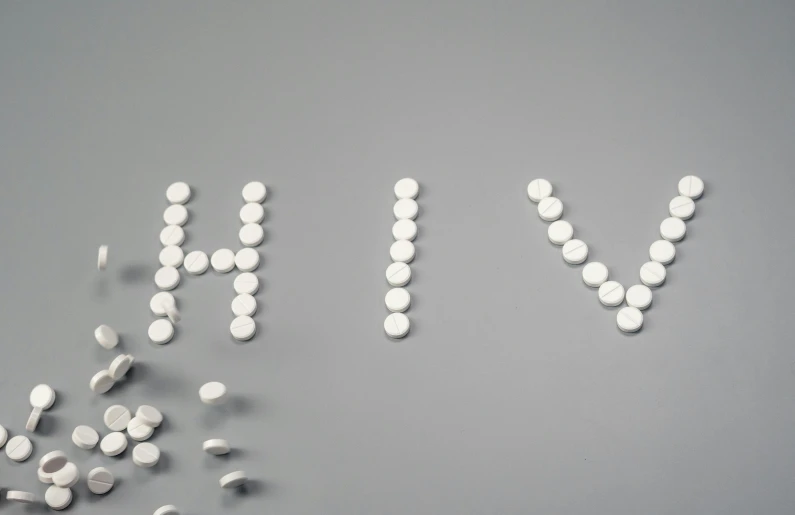 the word hiv spelled out of pills on a gray background, by Caroline Mytinger, trending on pixabay, antipodeans, 3 d white shiny thick, hive city, yin yang, an all white human