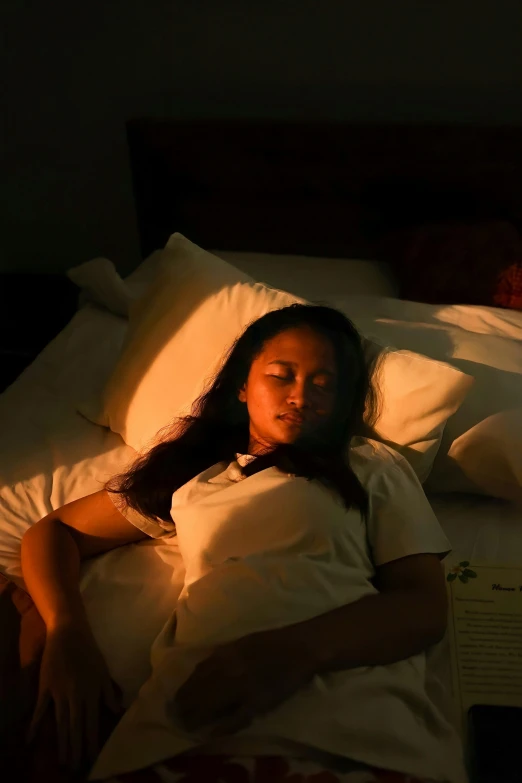 a woman laying in bed next to a lamp, pexels contest winner, cindy avelino, softlight, video still, student