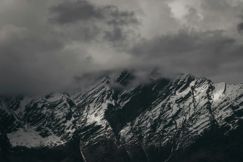 a black and white photo of a snow covered mountain, pexels contest winner, baroque, moody colors, 4 k hd wallpapear, thunderclouds, uttarakhand