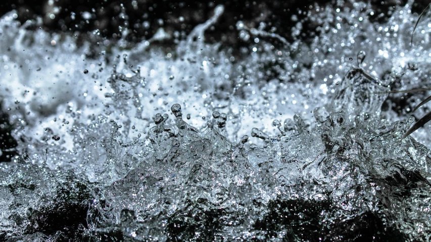 a close up of water splashing over rocks, by Micha Klein, unsplash, conceptual art, rain. hyper detailed, watercooling, thumbnail, blocked drains