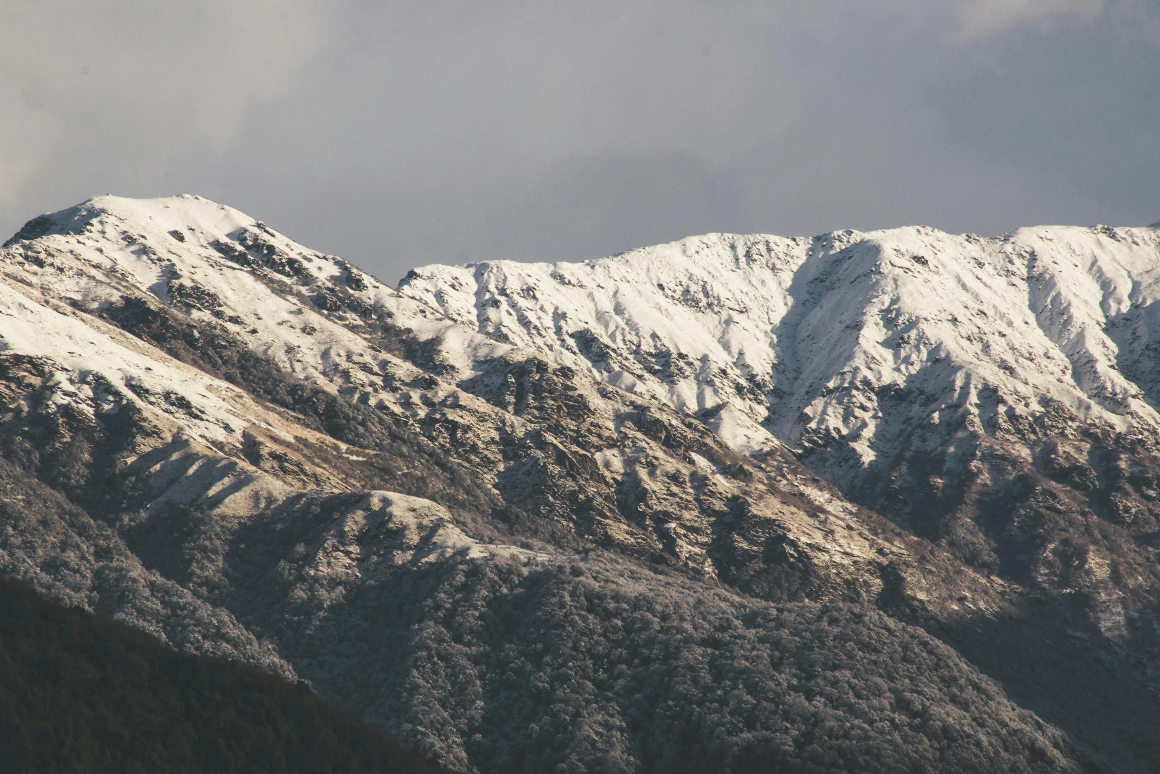 the mountains are covered in snow on a cloudy day, an album cover, pexels contest winner, hurufiyya, real engine 5 cinematic, boka, high details photo, mid morning lighting