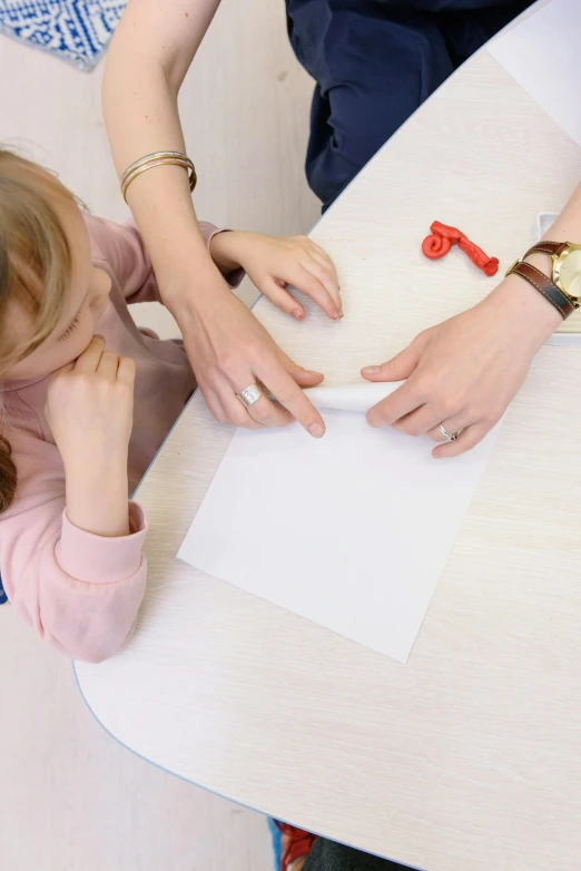 a woman and a little girl sitting at a table, a child's drawing, strong bespoke shape language, on vellum, thumbnail, with a white