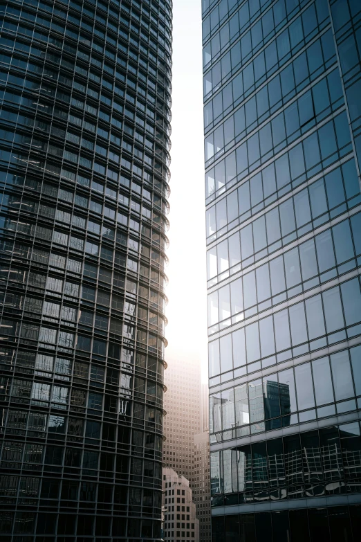 a couple of tall buildings next to each other, a picture, by Jan Rustem, translucent glass shine, cinematic image, precision, high-resolution