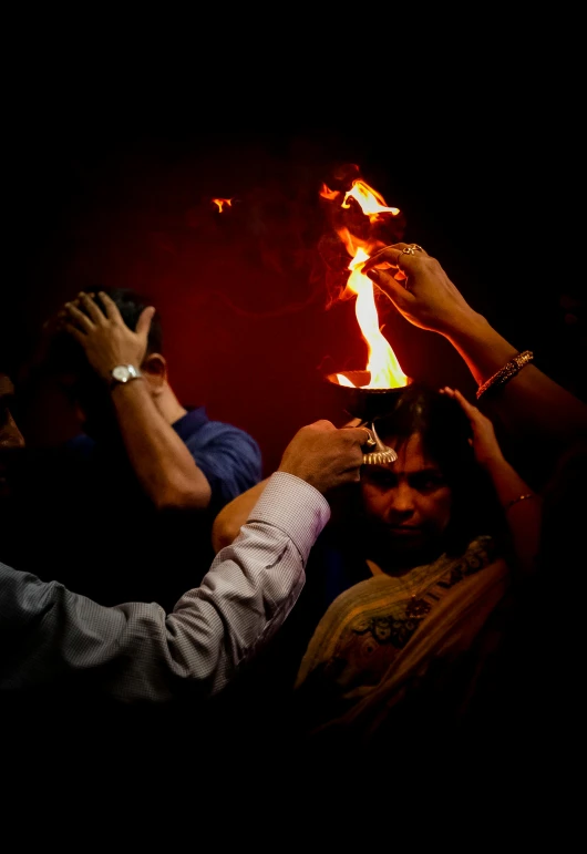 a group of people holding torches in the air, an album cover, pexels contest winner, symbolism, indian temple, fire from mouth, pray, avatar image