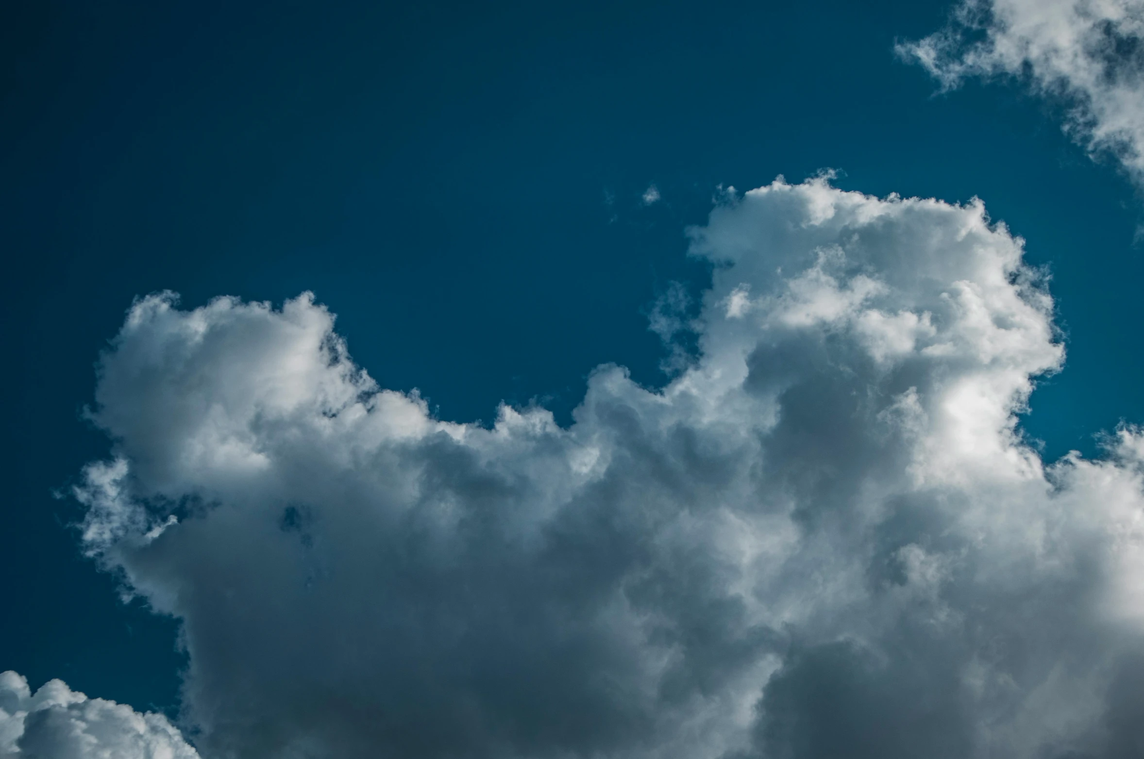 a jetliner flying through a cloudy blue sky, an album cover, inspired by Elsa Bleda, unsplash, minimalism, cumulus clouds, ignant, high definition photo