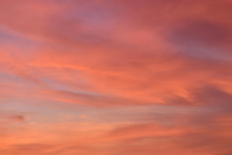 there is a plane that is flying in the sky, by Peter Churcher, unsplash, romanticism, orange / pink sky, soft light - n 9, altostratus clouds, close - up photograph