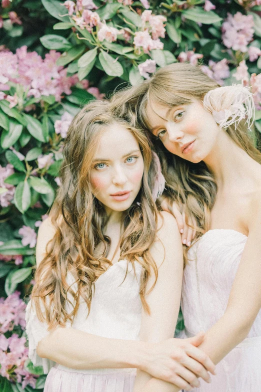 two women standing next to each other in front of flowers, inspired by Oleg Oprisco, unsplash, wedding, curls, 4k), 🎀 🧟 🍓 🧚