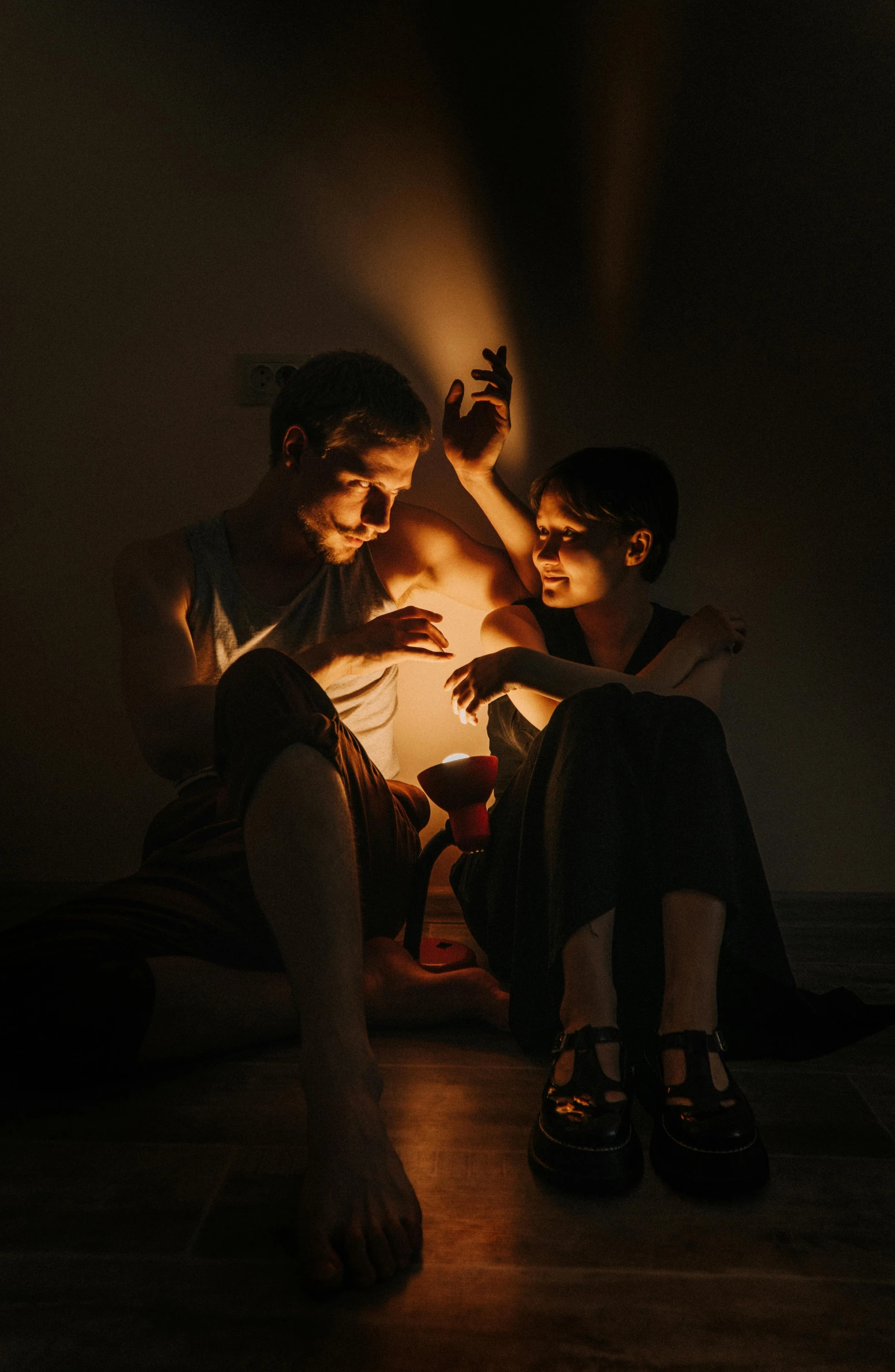 a couple of people that are sitting in the dark, holding a lantern, studio ambient lighting, intertwined, lena oxton