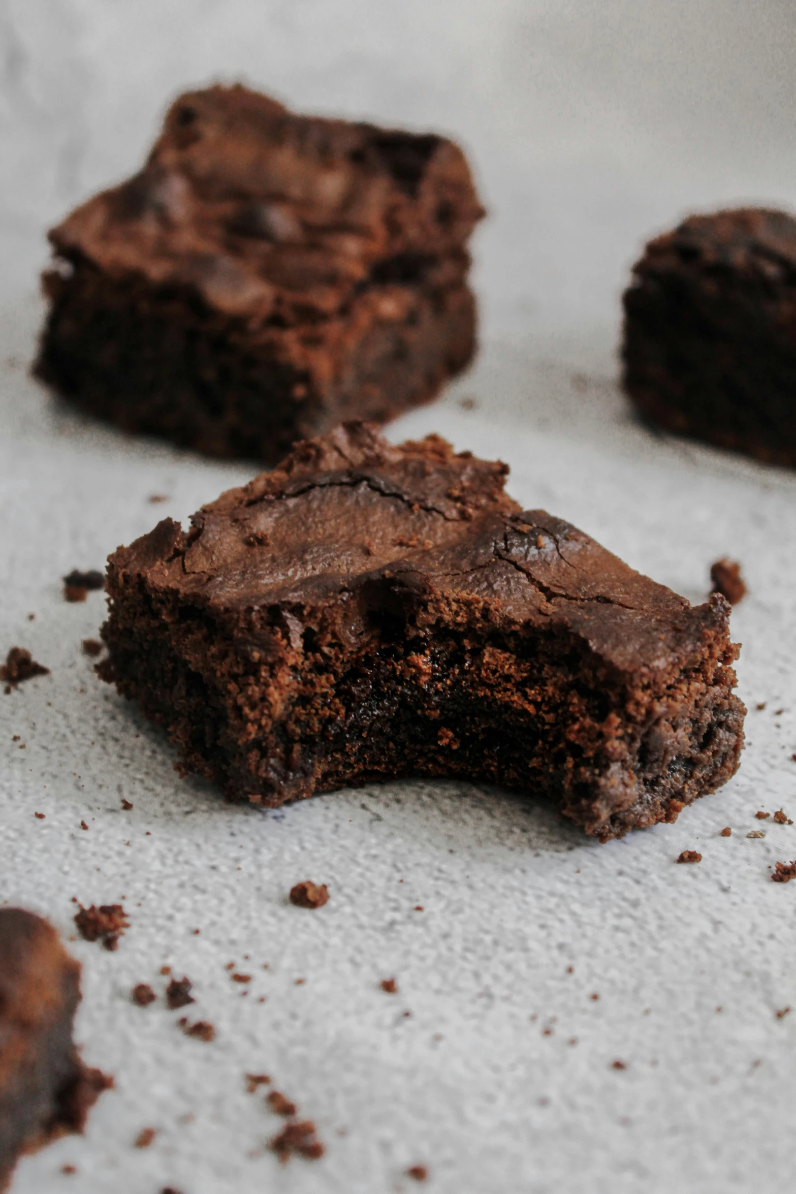 a close up of some brownies on a table, by Elsie Henderson, on grey background, half turned around, highly technical, square