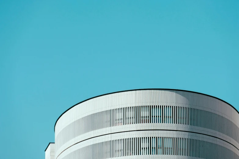 a white building with a blue sky in the background, pexels contest winner, rounded lines, in retro colors, telephoto shot, shot with hasselblad