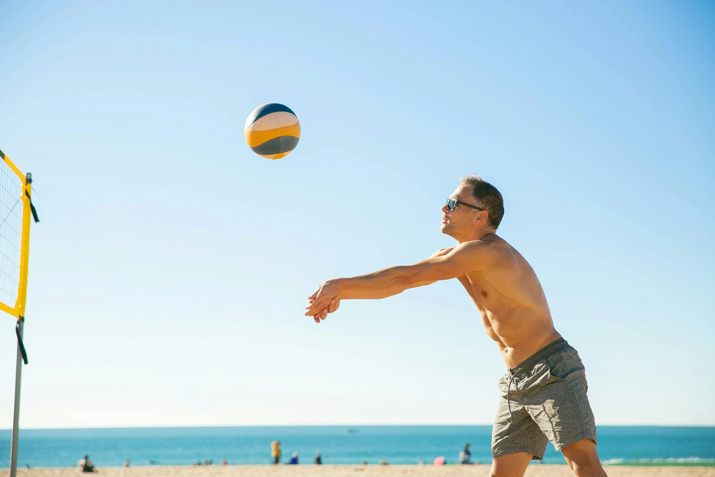 a man is playing volleyball on the beach, by Lee Loughridge, unsplash, on a hot australian day, super buff and cool, instagram post, clear and sunny