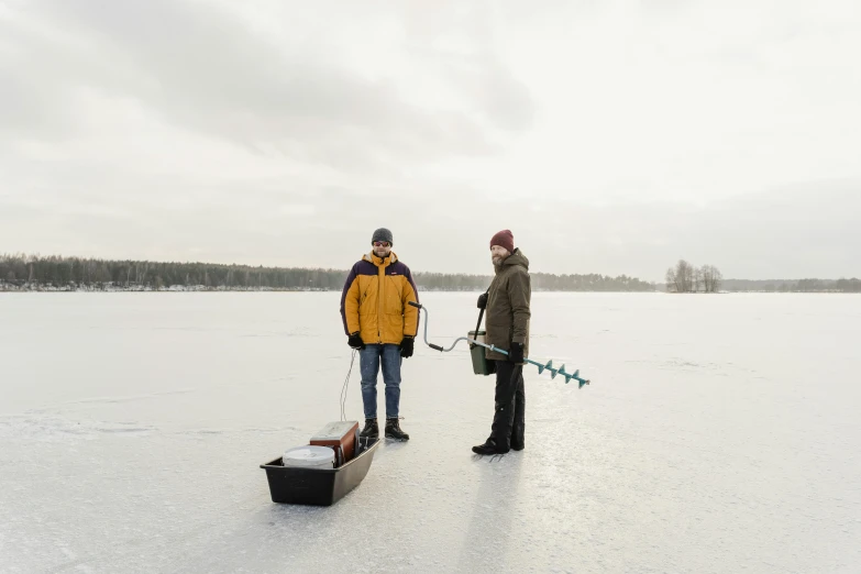 a couple of men standing on top of a snow covered field, by Veikko Törmänen, pexels contest winner, seafood in preserved in ice, instrument, winter lake setting, tv still