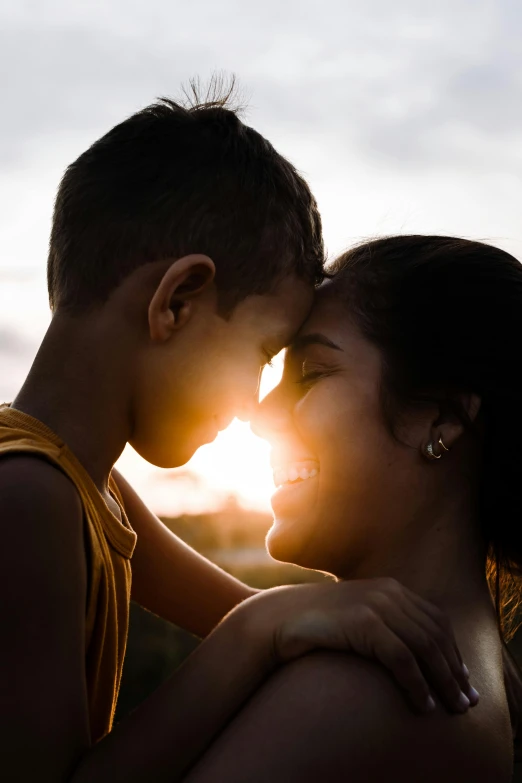 a couple of people standing next to each other, pexels contest winner, backlit beautiful face, motherly, boy and girl, hispanic