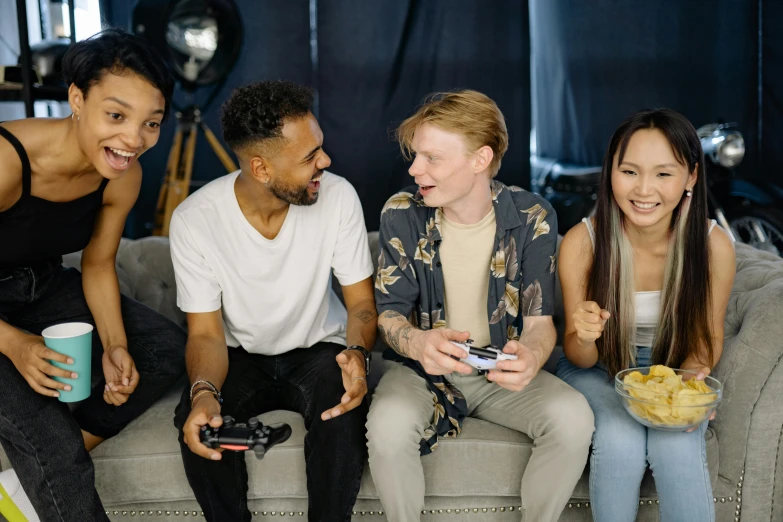 a group of people sitting on top of a couch, videogames, handheld, lgbtq, background image