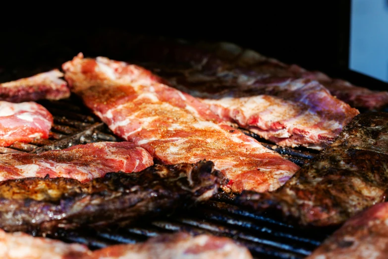 a close up of meat cooking on a grill, by Joe Bowler, ribs, profile image, fan favorite, flattened