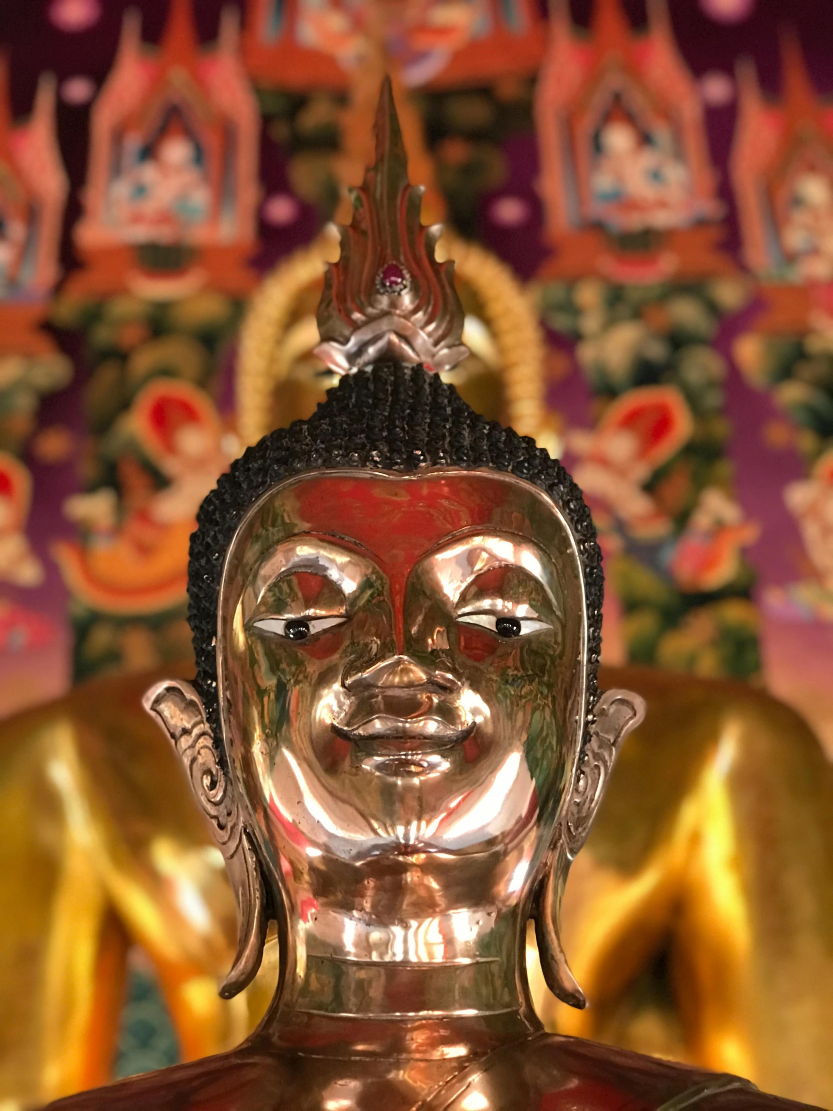 a close up of a statue of a person, in a temple, front facing the camera, gold, image