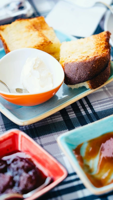 a close up of a plate of food on a table, by Lee Loughridge, unsplash, dau-al-set, eating cakes, syrup, square, bowl