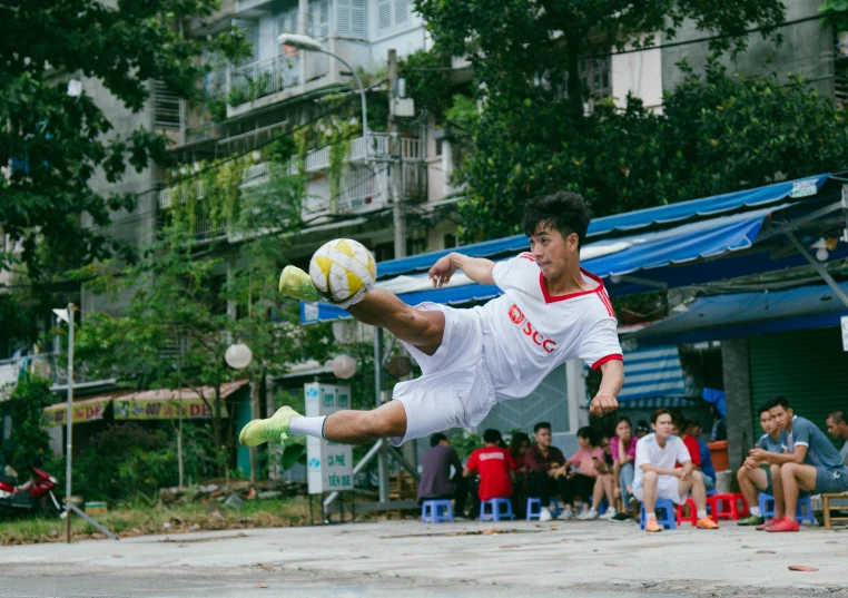 a man that is jumping in the air with a soccer ball, by Fei Danxu, pexels contest winner, realism, pretty face sharp chine, 15081959 21121991 01012000 4k, on the concrete ground, hoang long ly