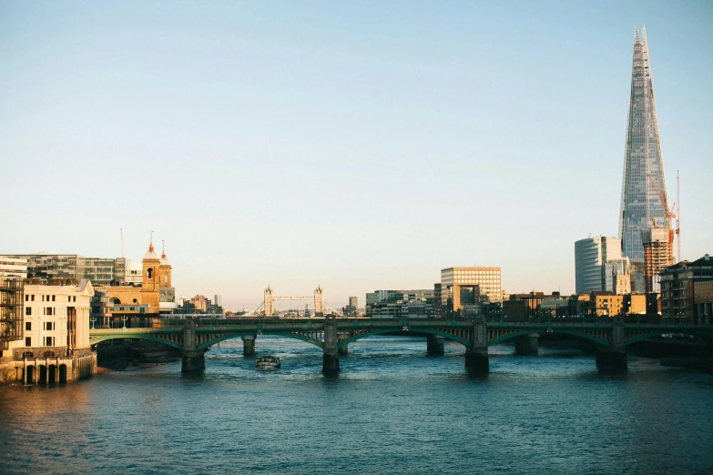 a view of the shard of the shard of the shard of the shard of the shard of the sha, a photo, pexels contest winner, bridge over the water, golden hours, 3 boat in river, lo-fi