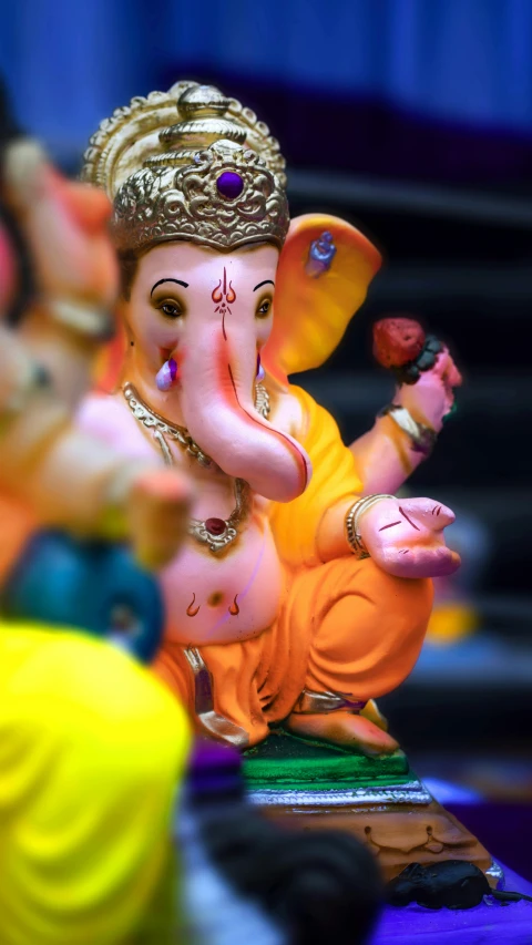 a close up of a statue of an elephant, pexels, pink and orange, ganesha, square, figurine