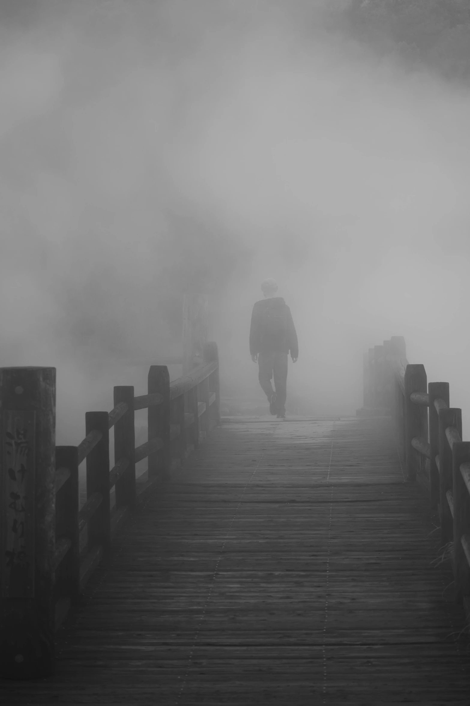 a person walking on a bridge in the fog, by Zheng Xie, egor letov, the mysterious stranger, menacing!!!, misty ghost town