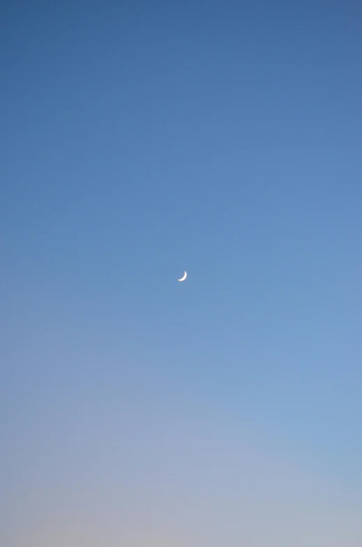 a plane that is flying in the sky, inspired by Jan Rustem, unsplash, postminimalism, moon in his crown, very sparse detail, ✨🕌🌙, the place is just really small