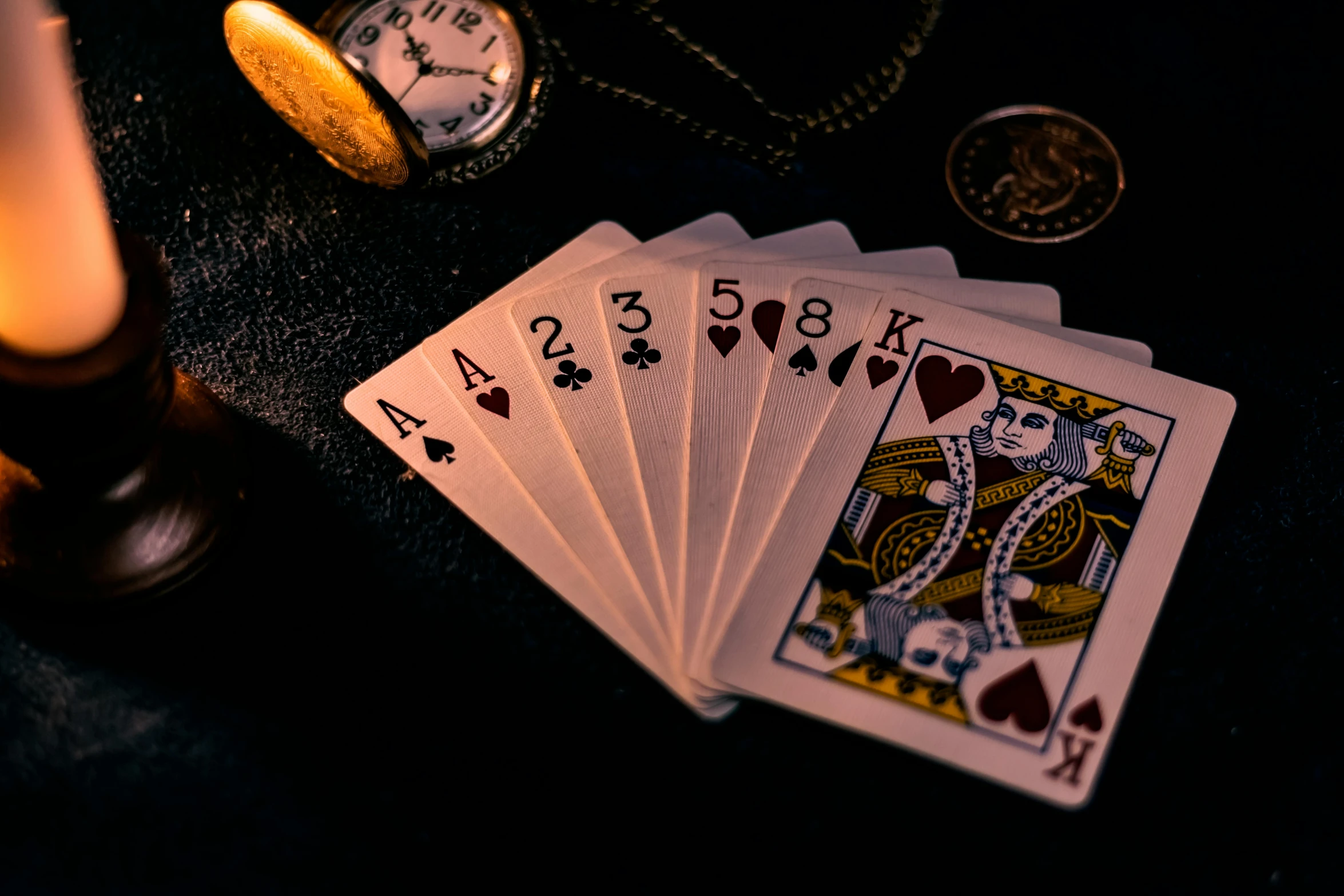 a bunch of playing cards sitting on top of a table, a still life, by Julia Pishtar, pexels contest winner, night time, pirate themed, medium close-up shot, thumbnail