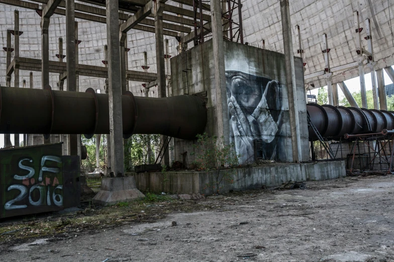 a building that has some graffiti on it, a portrait, pexels contest winner, nuclear art, huge obsidian structures, large pipes, historical photo