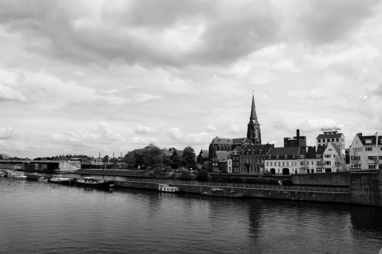 a black and white photo of a river, a black and white photo, by Jacob Kainen, pexels contest winner, church in the background, 1024x1024, panorama view, riverside