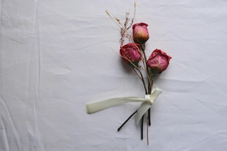 a bunch of flowers sitting on top of a white table, made of silk paper, buds, rule of three, without text