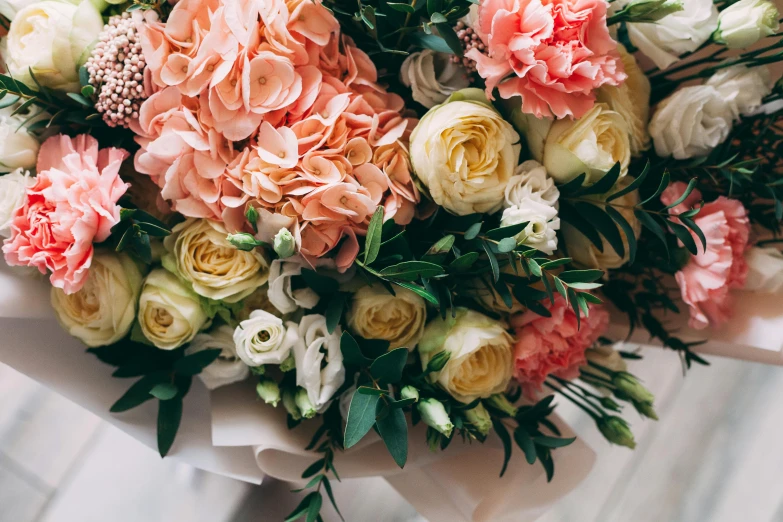 a bouquet of flowers sitting on top of a table, unsplash, romanticism, in shades of peach, low detail, highly polished, vibrantly lush