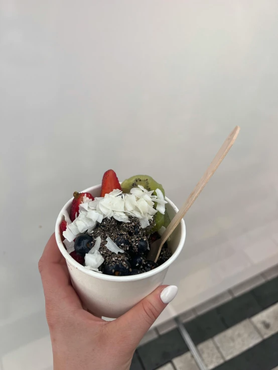 a close up of a person holding a bowl of food, a picture, 🎀 🗡 🍓 🧚, low quality photo, with a straw, dark. no text