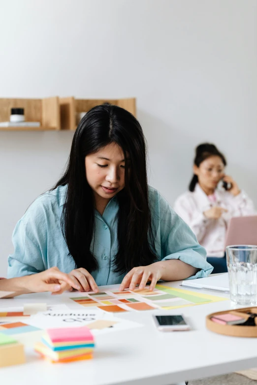 a group of people sitting around a white table, a cartoon, by Jang Seung-eop, trending on unsplash, an asian woman, carefully designed, behance lemanoosh, studious