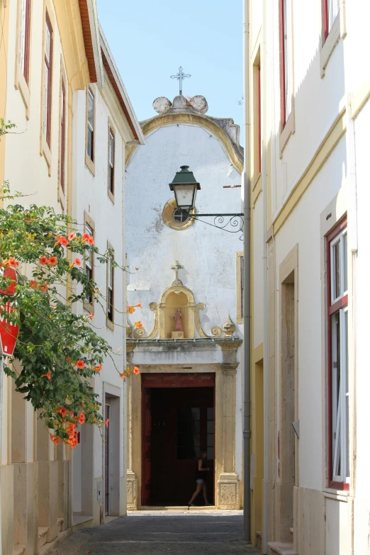 a narrow street with a church in the background, by Hirosada II, baroque, farol da barra, doorway, shrines, crisp image