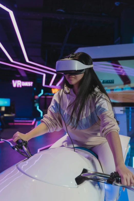 a woman sitting on top of a white surfboard, a hologram, interactive art, motorcycle helmet, wearing vr glasses, arcade, over-shoulder shot