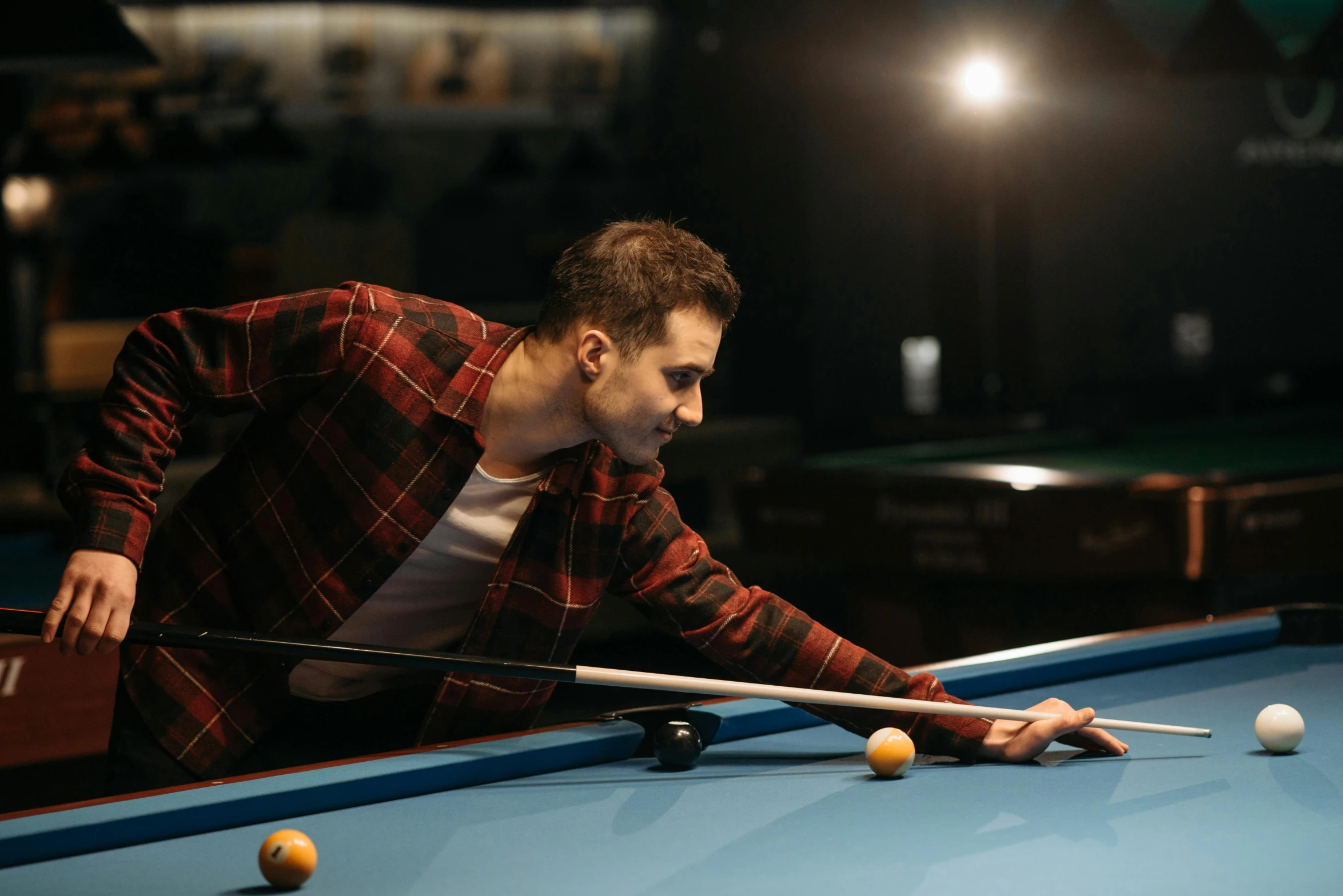 a man leaning over a pool table with a cue, pexels contest winner, profile pic, in an arena pit, thumbnail, brown