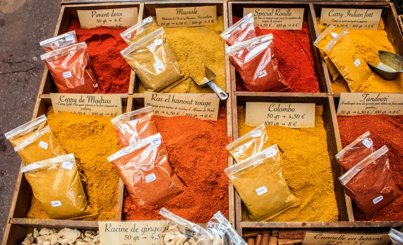 a box filled with lots of different types of spices, a photo, by Julia Pishtar, trending on unsplash, renaissance, yellow and red, france, conde nast traveler photo, market stalls