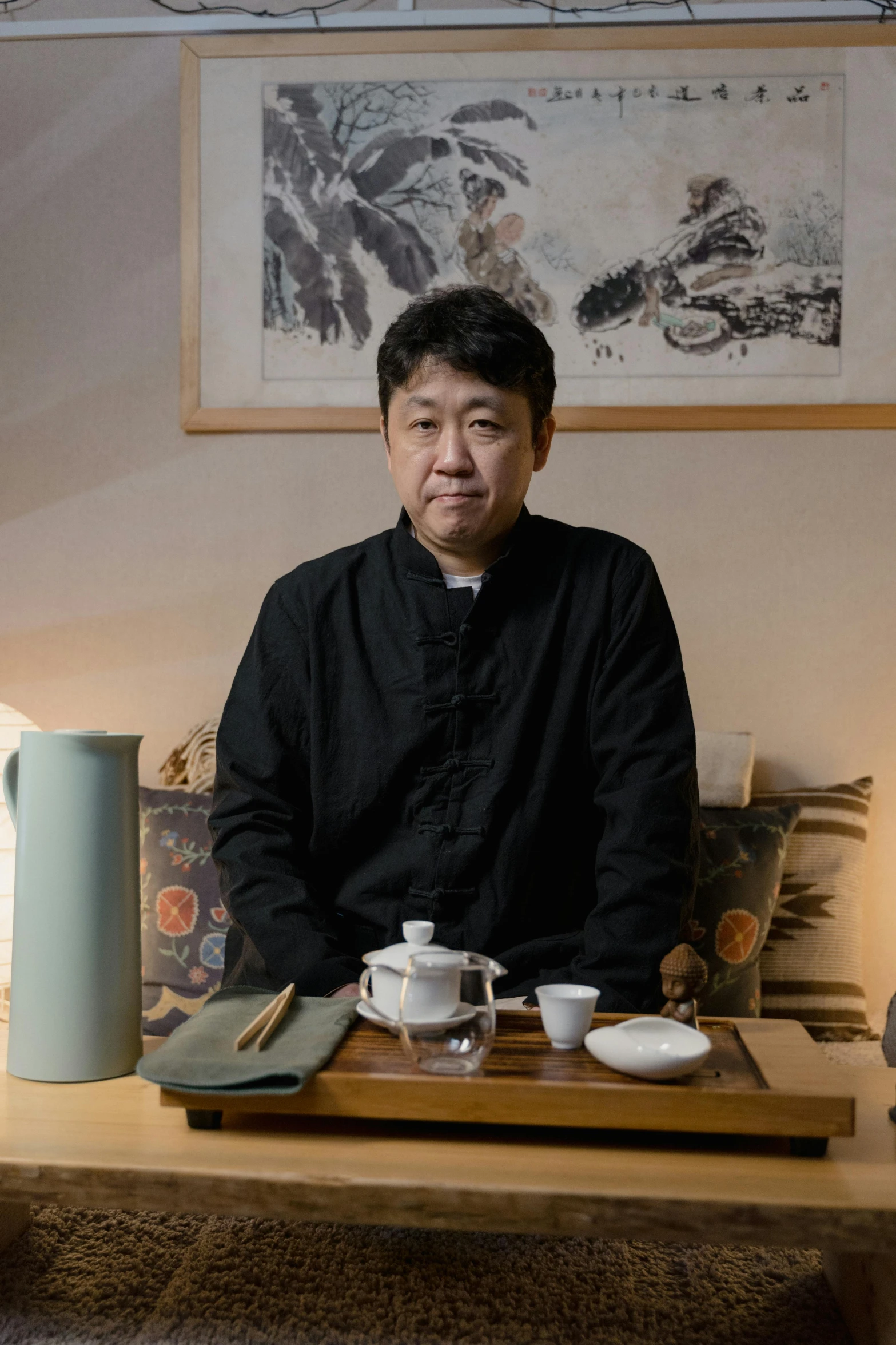 a man sitting at a table in a living room, inspired by Hashimoto Gahō, portrait photo, tea ceremony scene, chengyou liu, ready to eat